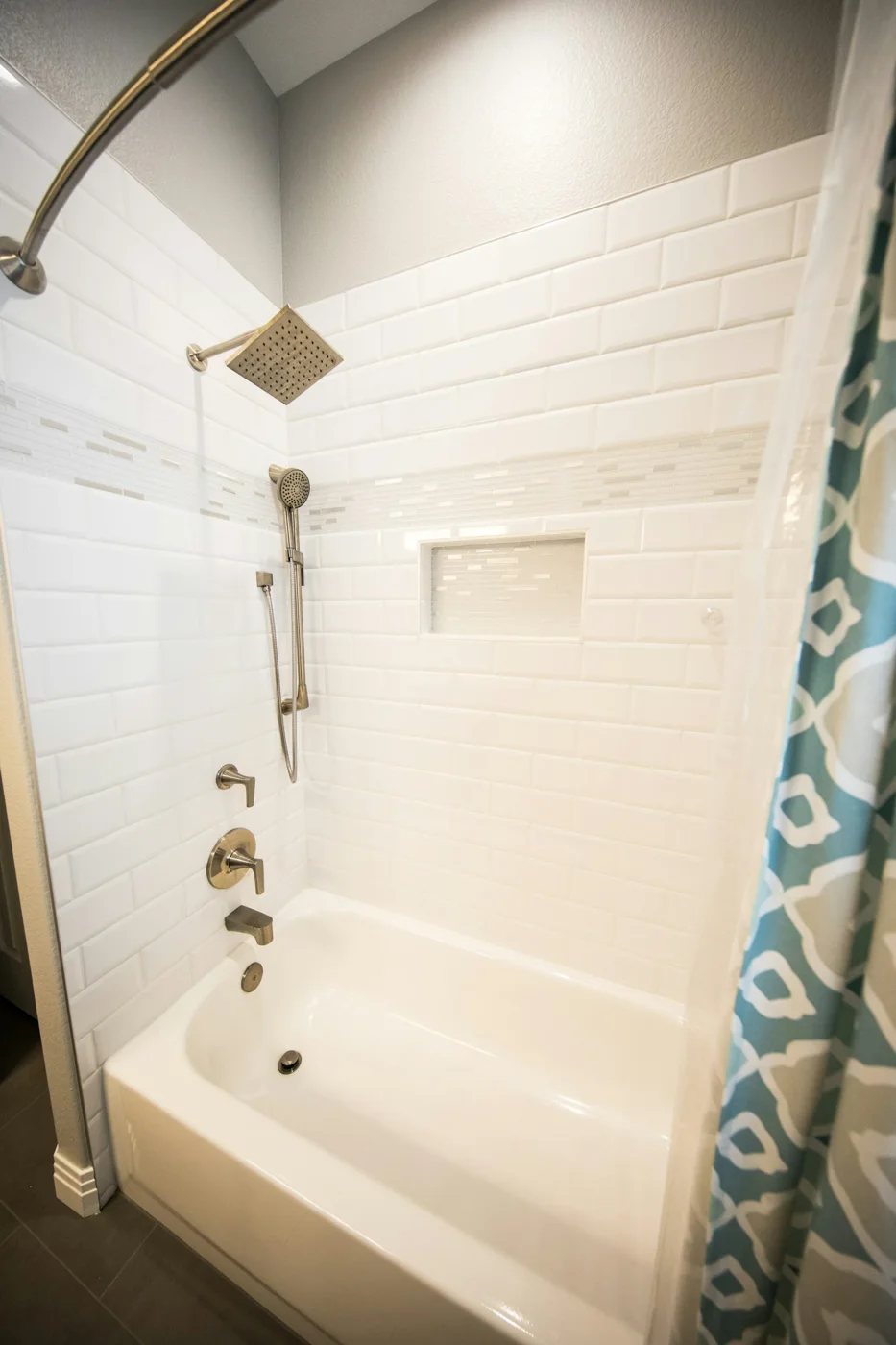 Tiled bathroom with bathtub and shower